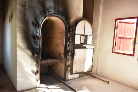 door for push wooden coffin to burning in cremation furnace buildingの写真素材