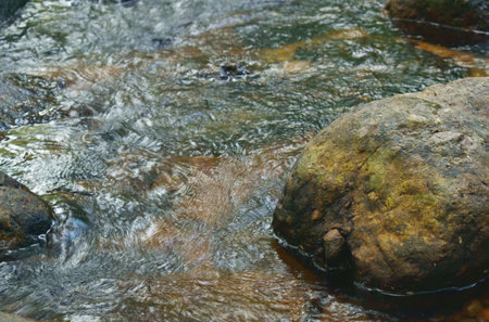 water falling on river pass rock and stone at Nang Rong waterfall travel location in Thailand