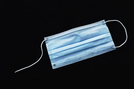 hygienic mask for protection nose and mouth with brake robe on black fabric background