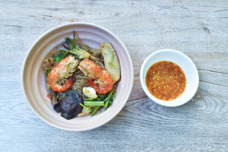 steamed shrimp with glass noodle and ginger on bowl dipping Thai spicy seafood sauce