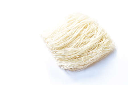 dry instant vermicelli thin noodles raw food arranging on white backgroundの写真素材