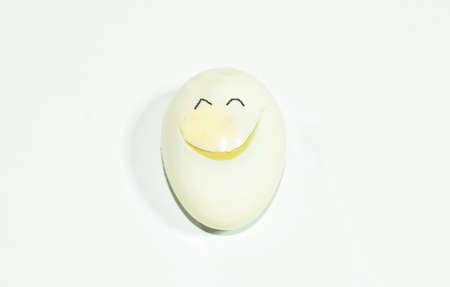 boiled egg shell out with smiling face on white background