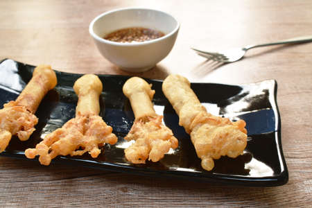 batter fried needles mushroom spring roll on plate dipping sweet ben sauceの写真素材