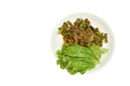 spicy fried chop duck meat with yard long bean and basil leaf on plateの写真素材