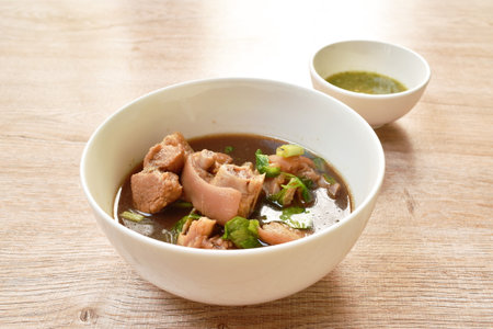 boiled salty pork leg in fish sauce soup on bowl dipping spicy sauceの写真素材