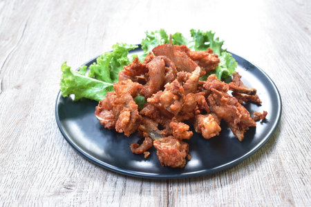 fried crispy salty chicken rib on plate eat couple fresh lettuce vegetable saladの写真素材