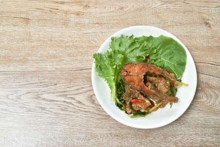 deep fried slice striped snake head fish with ginger and celery on dishの写真素材