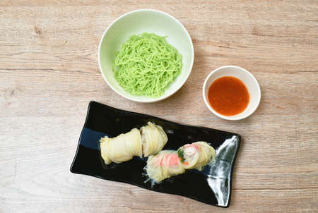 steamed Chinese cabbage stiffed glass noodles and carrot with crab stick on plate dipping sukiyaki sauce in cup eat couple Chinese jade noodlesの写真素材
