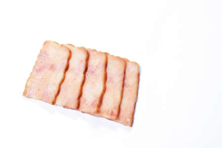 fried pork bacon slice arranging on white backgroundの写真素材