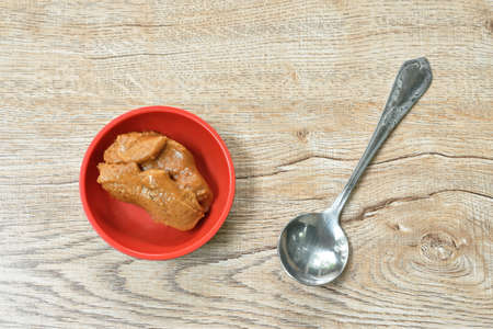 jaggery palm sugar in cup with silver spoon on table