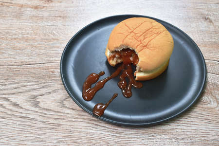 pork barbecue hamburger mayonnaise sauce with ketchup biting on plateの写真素材