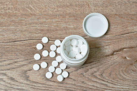 white tablet medicine in bottle on tableの写真素材