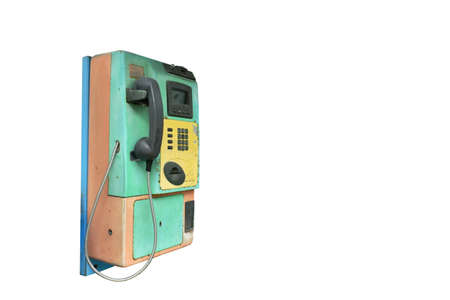 old and obsolete public telephone booth used by insert boin or card on white backgroundの写真素材