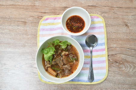 hot and spicy beef meat with tamarind and Thai herbs soup on bowl