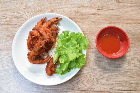 deep fried shrimp with flour on plate dipping spicy chili sauceの写真素材