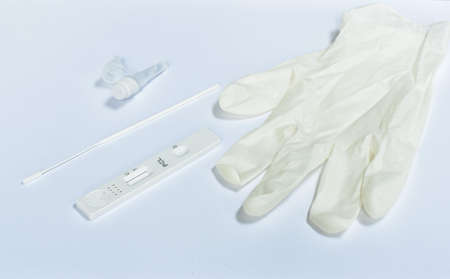 antigen test kit for checking virus with glove on white background