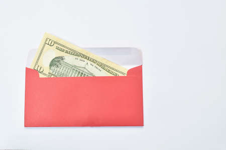 red envelope for reward youth in Chinese new year festival with ten US dollar on white backgroundの写真素材