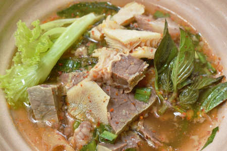hot and spicy beef meat and organ with tamarind and Thai herbs soup on bowl