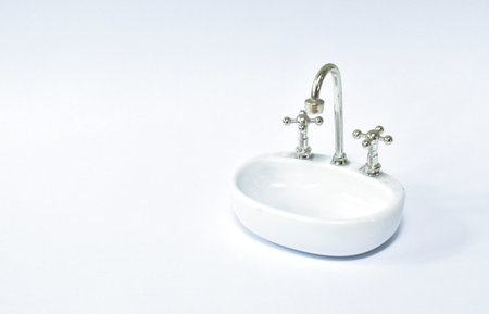 toy washing sink and water tap for used in bathroom on white backgroundの写真素材
