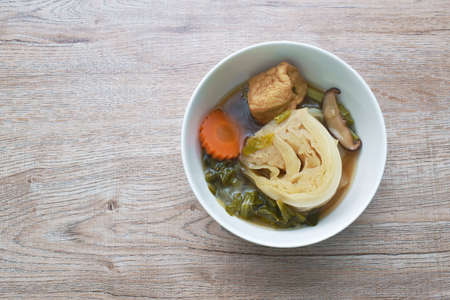 boiled cabbage with carrot and tofu topping slice mushroom vegetarian soup on bowl
