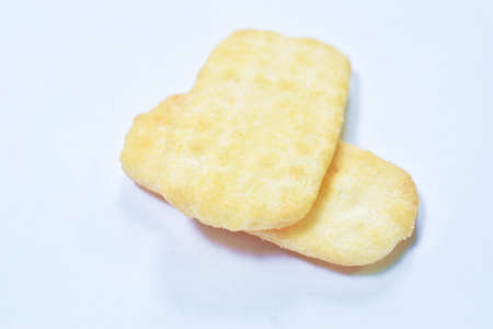 baking salty rice cracker snack arranging on white background