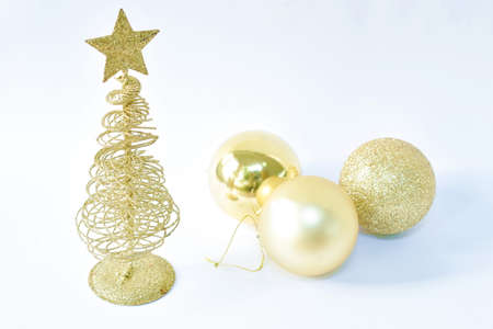 golden tree with star on top with ball for decoration in Christmas and new year festival on white backgroundの写真素材