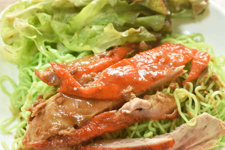 Chinese jade noodles topping slice roasted duck dressing sweet soy sauce on plateの写真素材