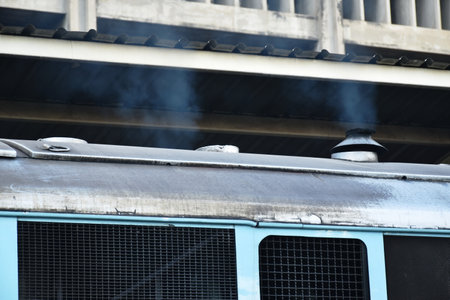 smoke from exhaust pipe of diesel train arrival at station platform in Thailandの写真素材