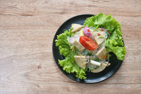 glass noodles with Vietnamese sausage and chop pork spicy salad on plate