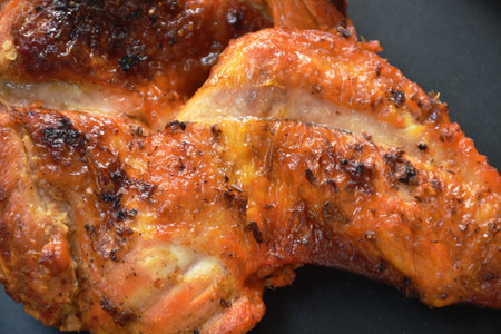 grilled chicken wing on plate dipping with spicy sauce