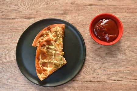 homemade Hawaiian pizza topping pork sausage and cheese dressing mashed dry oregano with ketchup on plateの写真素材
