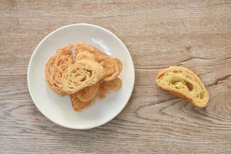 baking slice crispy butter croissant on plateの写真素材