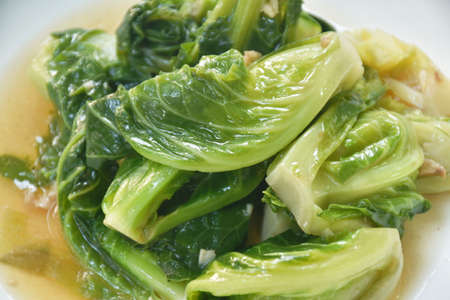 fried Brussels sprout in oyster sauce on plateの写真素材