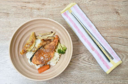 grilled salmon soy sauce with pork dumpling and vegetable topping on Japanese rice in bowlの写真素材