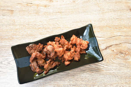 deep fried crispy salty chicken meat and gizzard on plateの写真素材