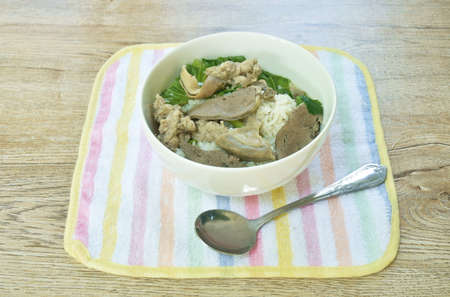 boiled rice with entrails and chop pork in soup on bowl