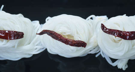 Thai rice noodles with spicy and sweet peanut sauce eat couple vegetable on plateの写真素材