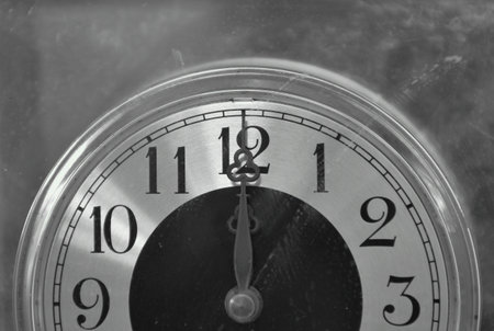 old long and short clockwises pointing on twelve o' clock at noon or midnight background