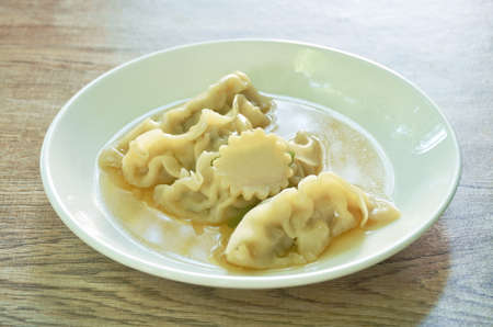 Gyoza Japanese boiled dumplings stuffed chop pork in soup on plateの写真素材