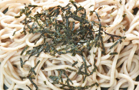 boiled cold yakisoba Japanese noodles topping dry slice seaweed on plate dipping soy sauceの写真素材