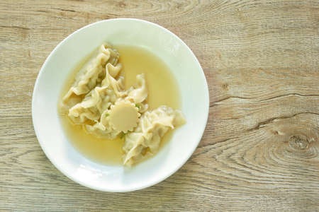 Gyoza Japanese boiled dumplings stuffed chop pork in soup on plateの写真素材