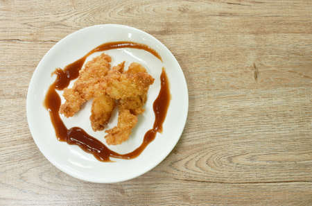 crispy fried chicken fillet with bread crumb and egg yolk on plate dipping ketchupの写真素材