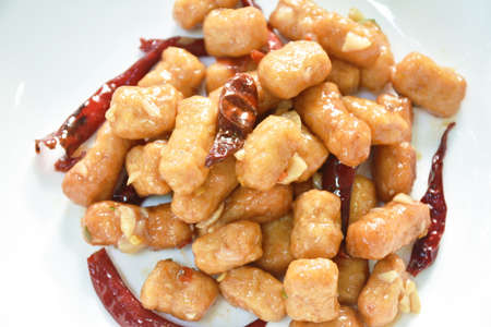 fried chicken meat with dry chili on plateの写真素材