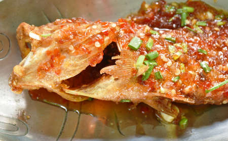deep fried red banded grouper fish dressing sweet chili sauce on plate