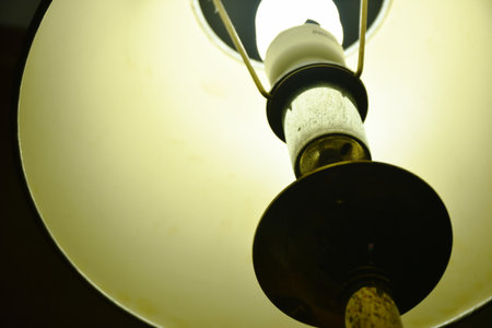 electric lamp hanging  from wall in the nightの写真素材