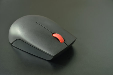 gray computer mouse on black laptop backgroundの写真素材
