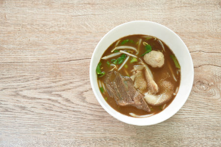 boiled braised beef and meatball in black herb soup on bowl