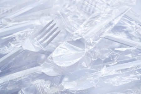plastic spoon and fork for single used in transparent packaging  arranging on white backgroundの写真素材