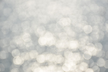blurry sea with reflection of sun on sunny day background and textureの写真素材