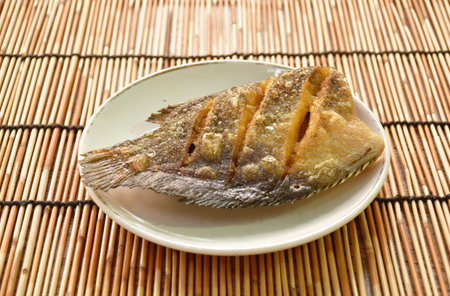 deep fried snake skin catfish or gourami on dishの写真素材